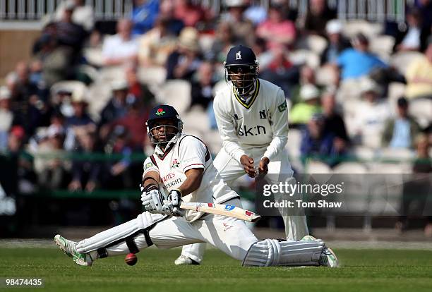 Ashwell Prince of Lancashire sweeps the ball during the LV County Championship match between Lancashire and Warwickshire at Old Trafford on April 15,...