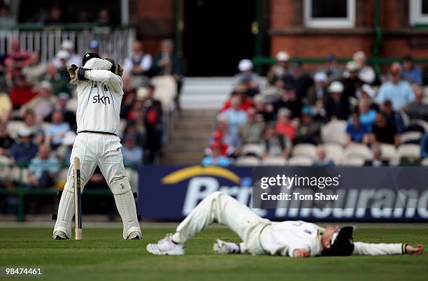 Tim Ambrose of Warwickshire hides his face as a throw from Ian Bell of Warwickshire just misses the stumps during the LV County Championship match...