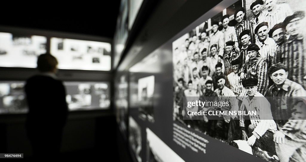 A visitor watches information panels dur