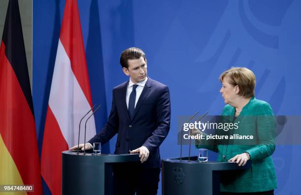 German Chancellor Angela Merkel speaks during a press conference with Austrian Chancellor Sebastian Kurz, after their meeting, at the German...