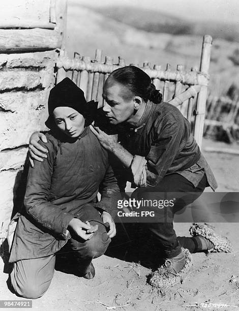 German actress Luise Rainer and American actor Paul Muni play Chinese peasants in the MGM film 'The Good Earth', 1937.