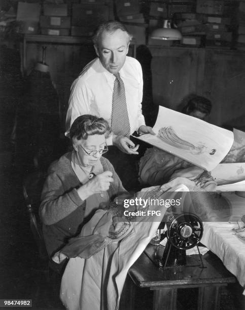 English fashion photographer and costume designer Cecil Beaton discusses his work with Mrs Garrett, a member of the wardrobe staff, 1945.