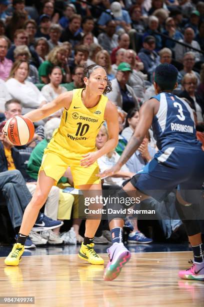 Guard Sue Bird of the Seattle Storm handles the ball against guard Danielle Robinson of the Minnesota Lynx on June 26, 2018 at Target Center in...