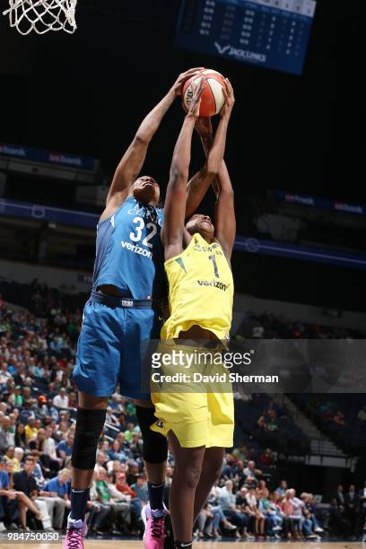 Forward Rebekkah Brunson of the Minnesota Lynx and forward Crystal Langhorne of the Seattle Storm jocks for a position during the game on June 26,...