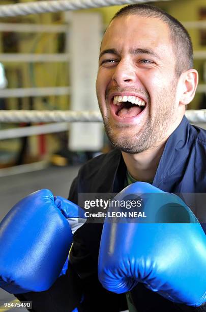 Chelsea footballer Joe Cole poses for pictures following a photocall with his friend professional boxer Kevin Mitchell at the TKO Ultrachem gym in...