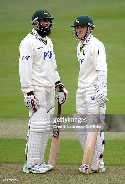 Hashim Amla and Chris Read of Nottinghamshire talk in the middle as they pile on the runs during the LV County Championship Match between...