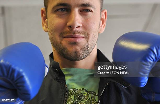 Chelsea footballer Joe Cole poses for pictures following a photocall with his friend professional boxer Kevin Mitchell at the TKO Ultrachem gym in...