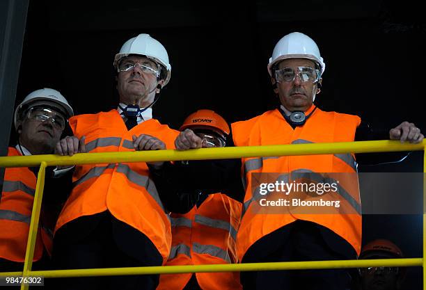 Christian Estrosi, France's industry minister, left, and Francois Fillon, France's prime minister, listen to a tour of the Cie. Saint-Gobain SA...