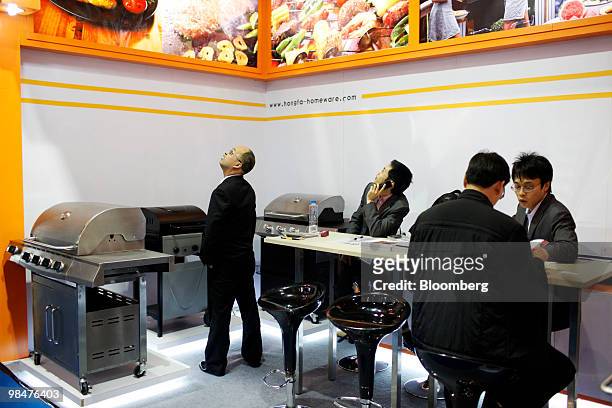Visitors look at a grill stand at the 107th China Import and Export Fair in Guangzhou, China, on Thursday, April 15, 2010. China's economic growth...