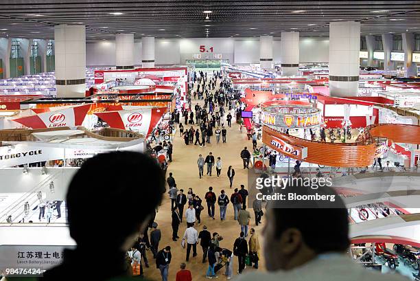 Visitors walk through the 107th China Import and Export Fair in Guangzhou, China, on Thursday, April 15, 2010. China's economic growth accelerated to...