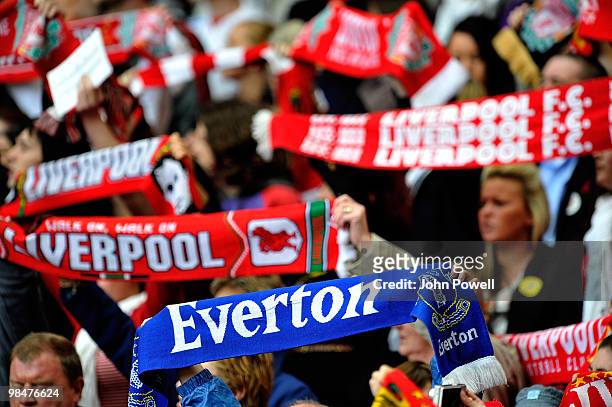 Supporters of Liverpool and Everton along with the family and friends of the 96 people who lost their lives at Hillsborough hold their scarves aloft...