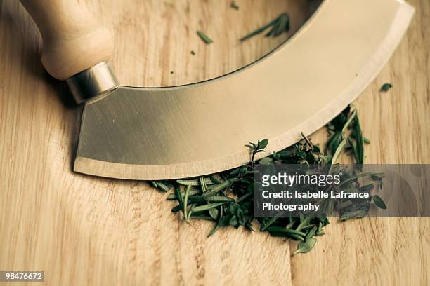 mezzaluna on wooden board with herbs - mincing knife stock pictures, royalty-free photos & images