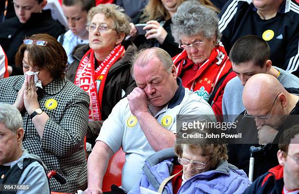 Liverpool fan wipes tears from his eyes during a memorial ceremony at Anfield on April 15, 2010 in Liverpool, England. Thousands of fans, friends and...