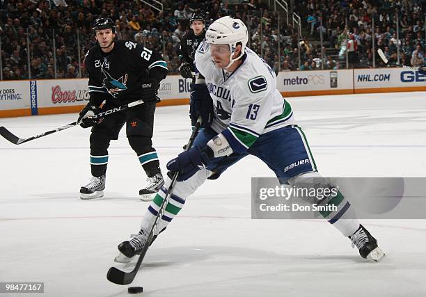 Matt Pettinger of the Vancouver Canucks keeps the puck away from Scott Nichol and Dany Heatley of the San Jose Sharks during an NHL game on April 8,...