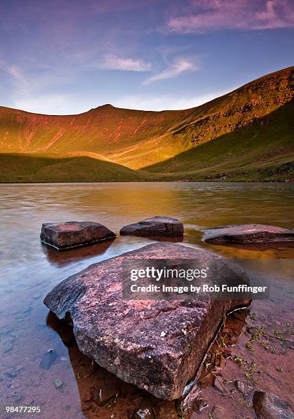 rocks in a small lake - pen y fan stock pictures, royalty-free photos & images