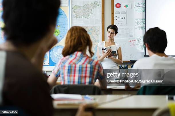 high school student reading book aloud to class - literatura e teatro imagens e fotografias de stock