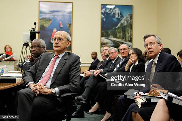 Supreme Court Justices Clarence Thomas and Stephen Breyer and their aides listen during a hearing before the Financial Services and General...