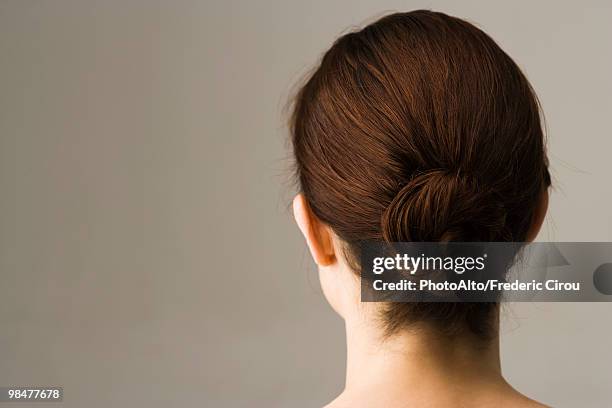 woman with hair arranged in chignon, rear view - hinterkopf stock-fotos und bilder