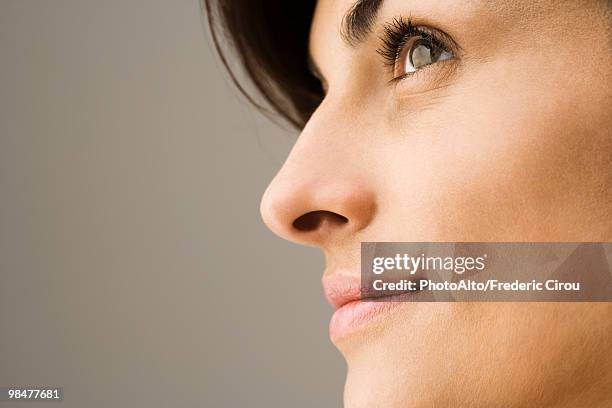 young woman contemplatively looking away, profile - anticipation face stock pictures, royalty-free photos & images