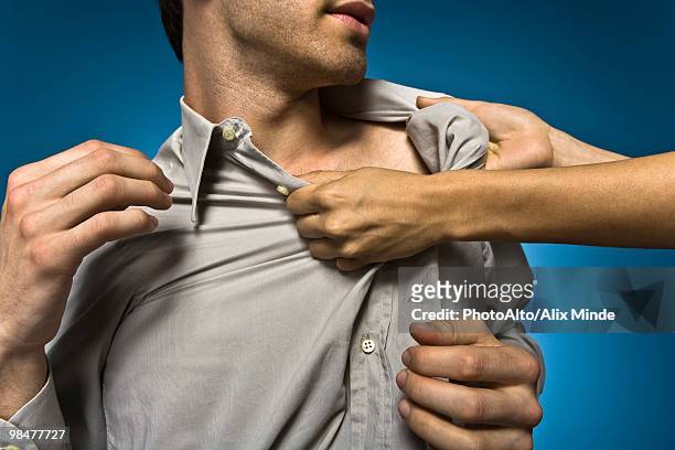 woman grabbing man by shirt collar - kragen stock-fotos und bilder