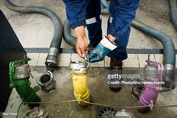 preparing to fill gas station fuel storage tanks - color coded stockfoto's en -beelden