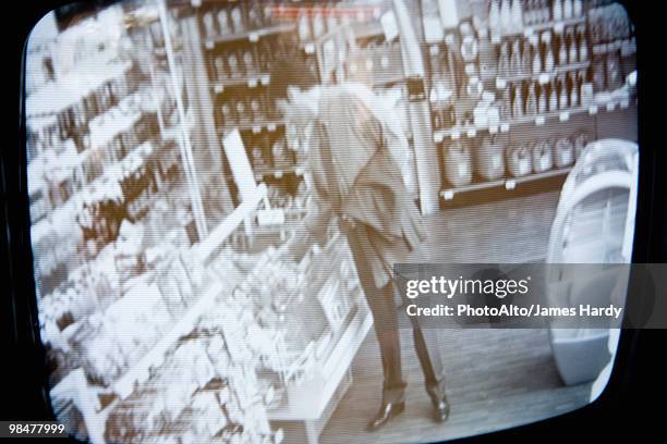 customer browsing in convenience store, image captured by surveillance camera - surveillance camera stock-fotos und bilder