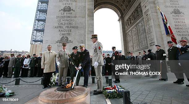 The commander of US and NATO troops in Afghanistan, General Stanley McChrystal and Chief of French army staff Edouard Guillaud light the flame at the...