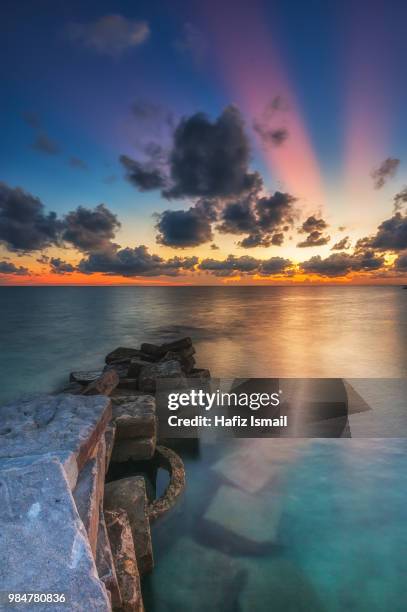 ray of light sunset at mabul island - mabul island stock pictures, royalty-free photos & images