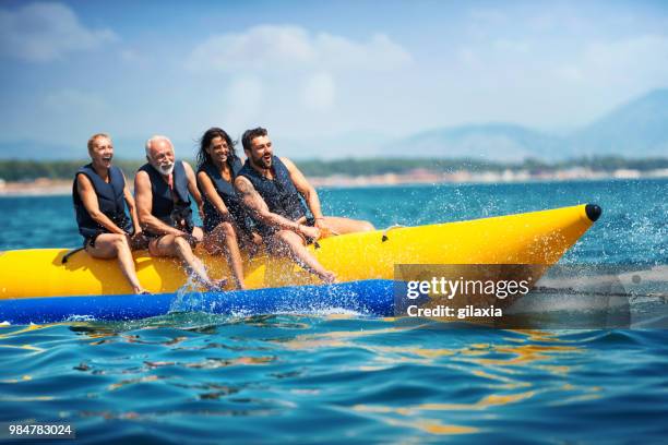 banana boat fun. - gilaxia stock pictures, royalty-free photos & images