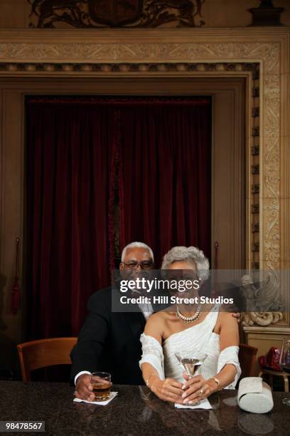 african american couple drinking at bar - boomer couple out on town stock-fotos und bilder