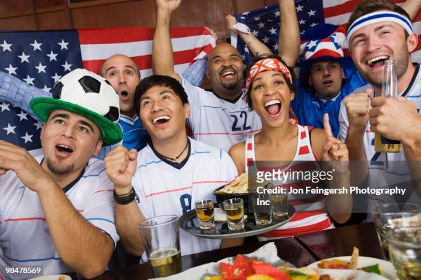 sports fans drinking and eating in sports bar - american football strip 個照片及圖片檔
