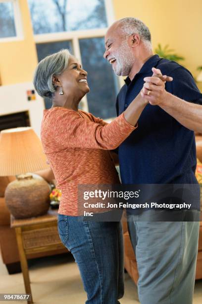 african american couple dancing in living room - jon feingersh stock pictures, royalty-free photos & images