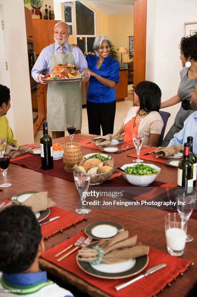 African American man serving Thanksgiving turkey