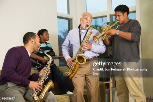 african american family playing saxophone together - jon feingersh stock pictures, royalty-free photos & images