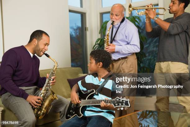 african american family playing musical instruments together - jon feingersh stock pictures, royalty-free photos & images