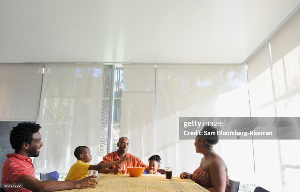 Black family eating at dining room table