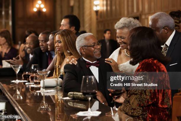 african american people drinking at bar - boomer couple out on town stock-fotos und bilder