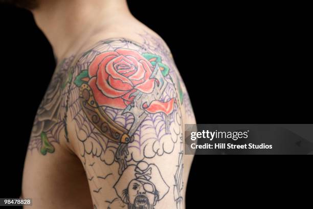 tattooed shoulder of hispanic man - tattoo shoulder stock pictures, royalty-free photos & images