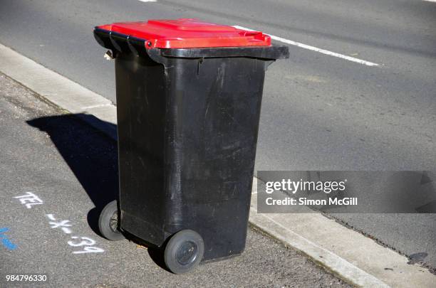 plastic wheeled rubbish bin on the sidewalk for rubbish collection - wheeled garbage can stock pictures, royalty-free photos & images