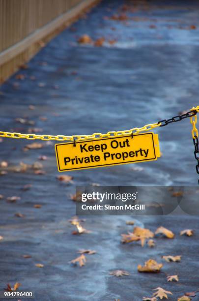'keep out: private property' sign on a plastic chain across a driveway - private property stock pictures, royalty-free photos & images