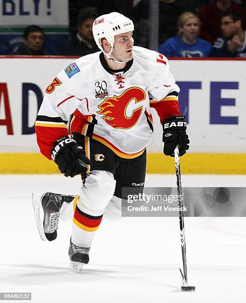 Ian White of the Calgary Flames skates up ice with the puck during their game against the Vancouver Canucks at General Motors Place on April 10, 2010...