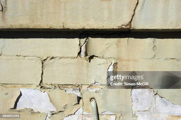 faded paint peeling off a brick exterior wall - peeling off bildbanksfoton och bilder