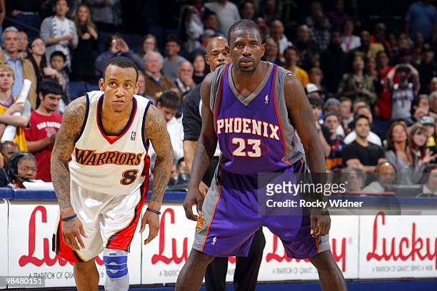 Monta Ellis of the Golden State Warriors and Jason Richardson of the Phoenix Suns stand ready for play to resume during the game at Oracle Arena on...