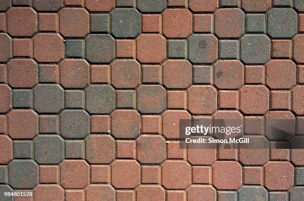 interlocking paving stones in an octagonal and square pattern - cobblestone pattern stock pictures, royalty-free photos & images