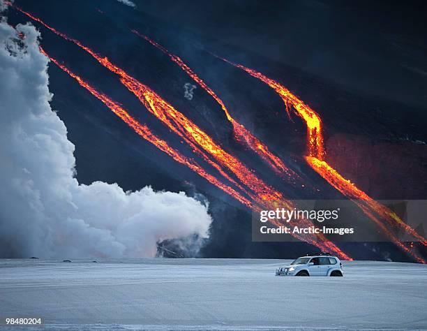 vehicle close to volcano eruption. - fimmvorduhals volcano stock pictures, royalty-free photos & images