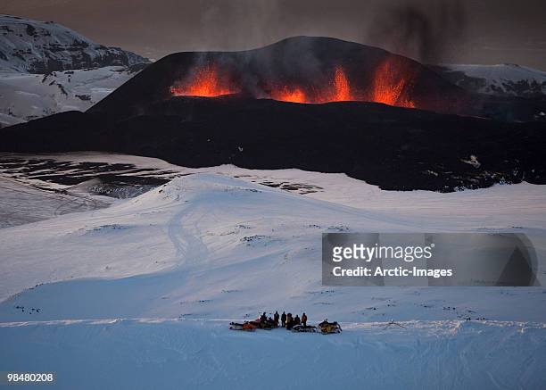tourists watching the lava fountains - fimmvorduhals volcano imagens e fotografias de stock