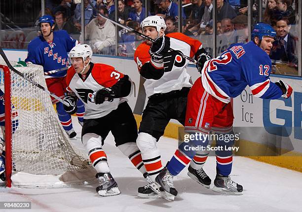 Olli Jokinen of the New York Rangers skates against Ian LaPerriere of the Philadelphia Flyers on April 9, 2010 at Madison Square Garden in New York...