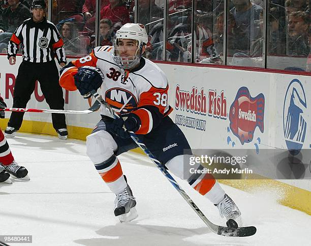 Jack Hillen of the New York Islanders plays the puck against the New Jersey Devils during the game at the Prudential Center on April 10, 2010 in...