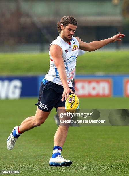 Tom Boyd of the Bulldogs kicks during a training session at Whitten Oval on June 27, 2018 in Melbourne, Australia.