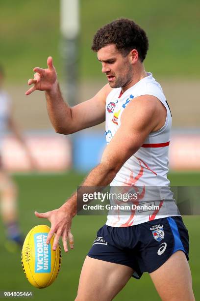 Kieran Collins of the Bulldogs kicks during a training session at Whitten Oval on June 27, 2018 in Melbourne, Australia.